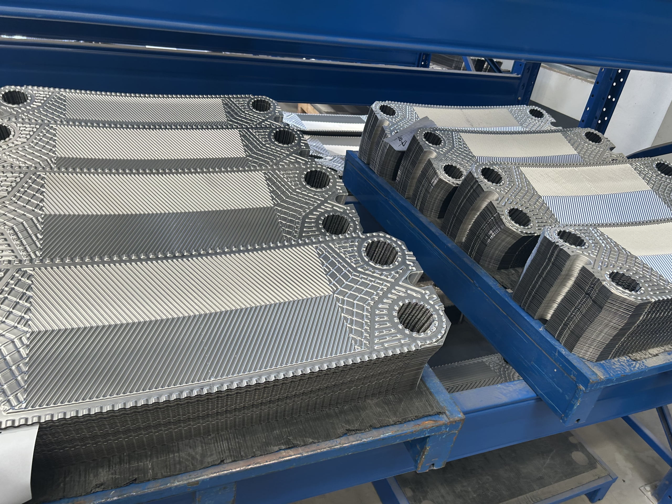 alt text: TIVO aftermarket Alfa Laval gaskets and plates being inspected for quality control